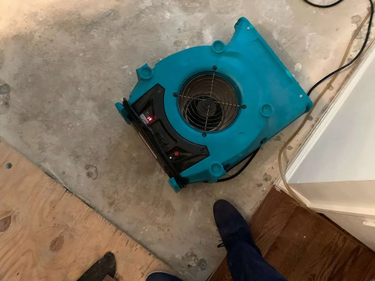 Air mover drying subfloor during Commercial Water Damage Restoration in Evesham